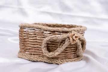 Obraz premium Woven basket for wedding birthday flower arrangement on white sa