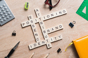 Conceptual business keywords on table with elements of game making crossword