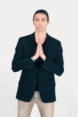 Handsome man doing different expressions in different sets of clothes: prayer