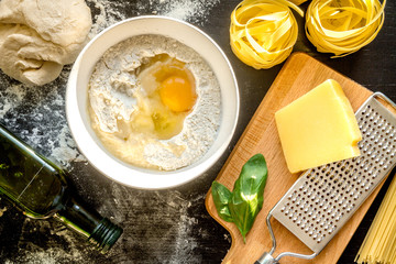 cooking process of pasta on dark background top view