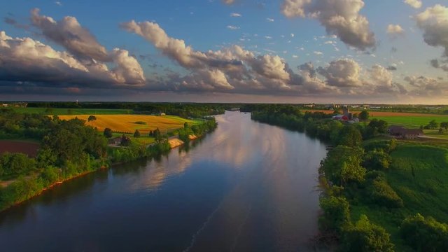 Stunning aerial view of breathtaking sky over tranquil river at dusk.
