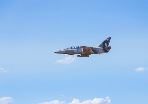 L-39 albatros fighter jet flying on sunset  background on white blue sky  background  