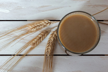 Traditional Drink from Balkan Peninsula Boza (fermented cereal beverage) and wheat over white...