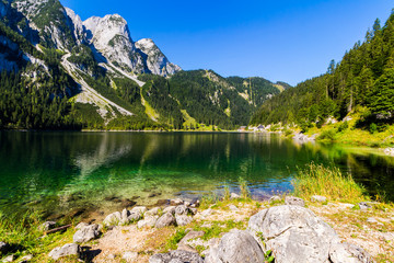 Fantastic azure alpine lake Vorderer Gosausee. Unusual and picturesque scene. Salzkammergut is a famous resort area located in the Gosau Valley in Upper Austria. Dachstein glacier. Beauty world.