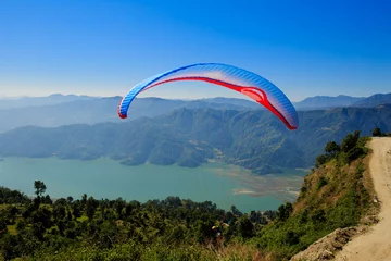 Tuinposter Pokhara, Nepal - November 3rd, 2016: View of a paraglider preparing to launch itself in the air. © lzf
