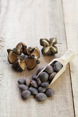 dried capsule seeds fruit of Sacha Inchi peanut on wooden