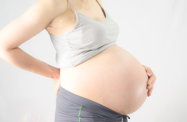 Pregnant woman with back pain on white background