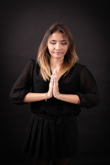 Beautiful woman doing different expressions in different sets of clothes: prayer