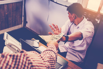 Image of disgusted male employee refusing to take bribe. money c