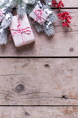 Wrapped christmas presents, fur tree branches, red berries on ag