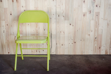 Obraz na płótnie Canvas wooden wall pine Light color / green chair