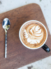 cappuccino cup on top old wood