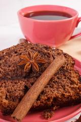 Dark cake with chocolate, cocoa and plum jam, cup of coffee, delicious dessert
