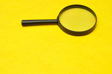 Magnifying glass isolated on a yellow background