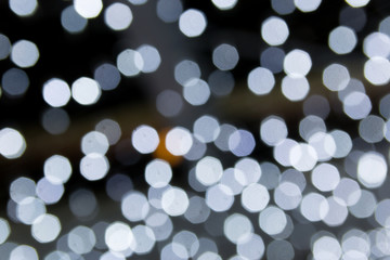 Night bokeh lights of Christmas garland on dark background