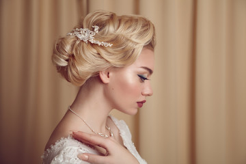 Portrait of beauty bride in white dress with classic hairstyle.