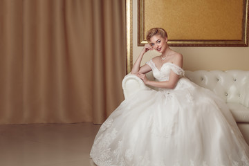 Fototapeta premium Portrait of beautiful cheerful bride in white dress. Classic sty