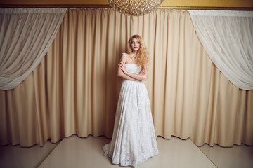 Full length portrait of beauty bride in white dress. Classic sty