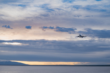 Sunset in Alaska with Plane is landing