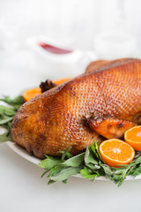 Roasted  duck in honey glaze with spicy herbs and tangerines