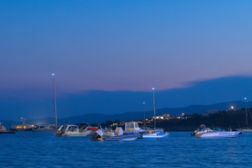 Fototapeta na wymiar Alyki port in Paros island full of motor boats and fish boats. 