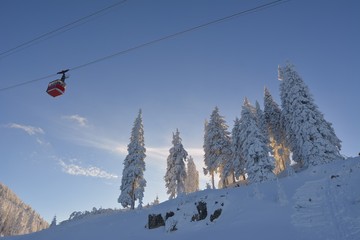 Fototapeta na wymiar Cable car on ski resort with blue sky background