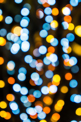 Abstract blue, yellow and orange bokeh light isolated with black  background. It is used for background and pattern.