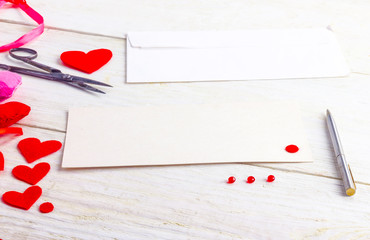 congratulations on Valentine's Day, blank cards with envelopes and empty valentine on a wooden table