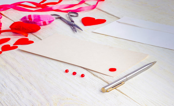 congratulations on Valentine's Day, blank cards with envelopes and empty valentine on a wooden table
