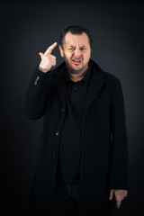 Fototapeta premium Handsome man doing different expressions in different sets of clothes: you are crazy