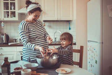 fun young pregnant mother   with son Toddler, make  dough for ba