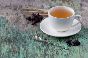 A cup of hot herbal tea on the old wooden background. Cup of tea herbal tea hot drink vintage...