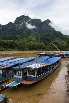 Long boats on the river with mountain