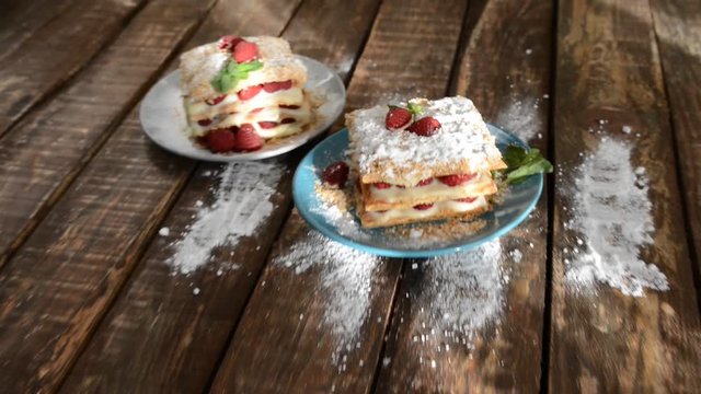 Raspberry Mille-feuille with cinnamon on dark wooden Board.