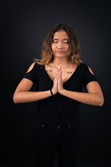 Naklejka premium Beautiful woman doing different expressions in different sets of clothes: prayer