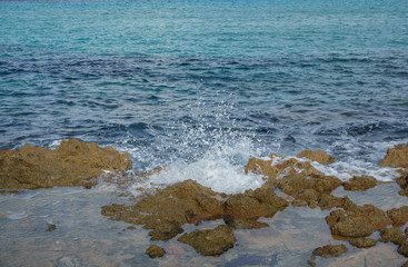Fototapeta na wymiar Detailed view of waves breaking on a stony beach