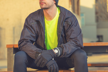 Urban jogger making a pause on the bench.