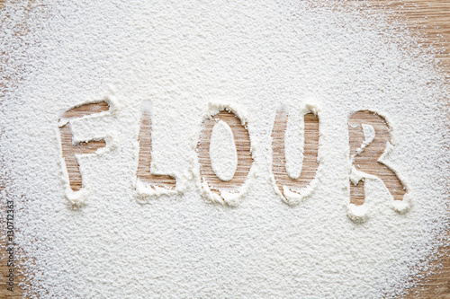 "Word flour in the white flour on the wooden table." Stock photo and ...