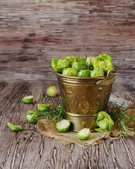 Green raw Brussels sprouts in wooden bowl , selective focus