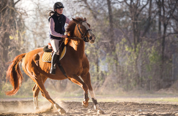 Young girl riding a horse