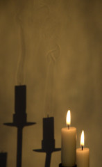 burning candles and shadow of smoke 