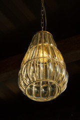 Obraz premium Single beautiful lamp hanged to the ceiling by chain