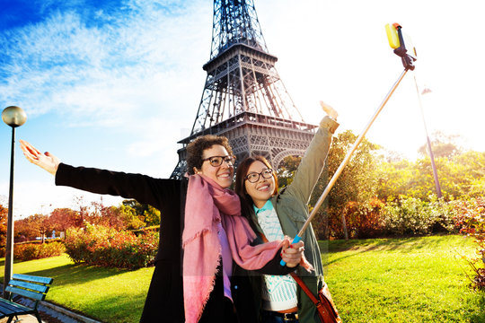 Tourists taking selfie against the Eiffel Tower