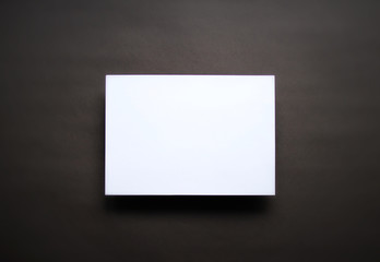 Empty white paper sheet dark brown background