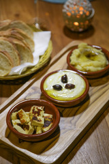 Bowls of sour cream, mashed potato and cheese, dip sauces on wooden table, dinner time