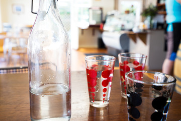 glasses and bottle with water on table