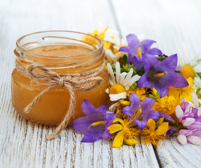 Jar of honey with wildflowers