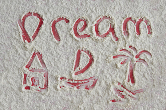 Word dream and pictures of home, boat, palm on flour background