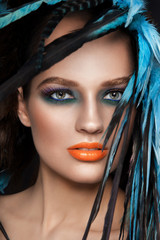 Close-up HD portrait of young beautiful woman with fancy make-up
