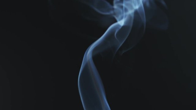 closeup video of blue smoke rising over black background in 180fps slow motion, prores footage